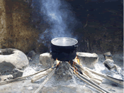 Profuse quantities of smoke are produced while cooking using the traditional three stone cooking method in the Gambia 