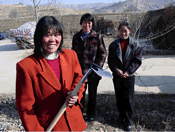 Women in Gansu Province examining improved potato hoe that reduces labour requirements